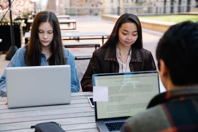 Students studying together on laptops
